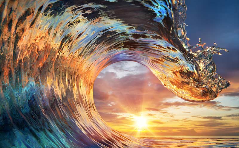 close-up of a wave with the sunset in the background